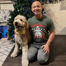 customer wearing a christmas dog-themed shirt to match with his goldendoodle